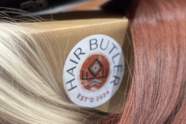 blonde and red hair around a Hair Butler™ hair extension workstation tool box