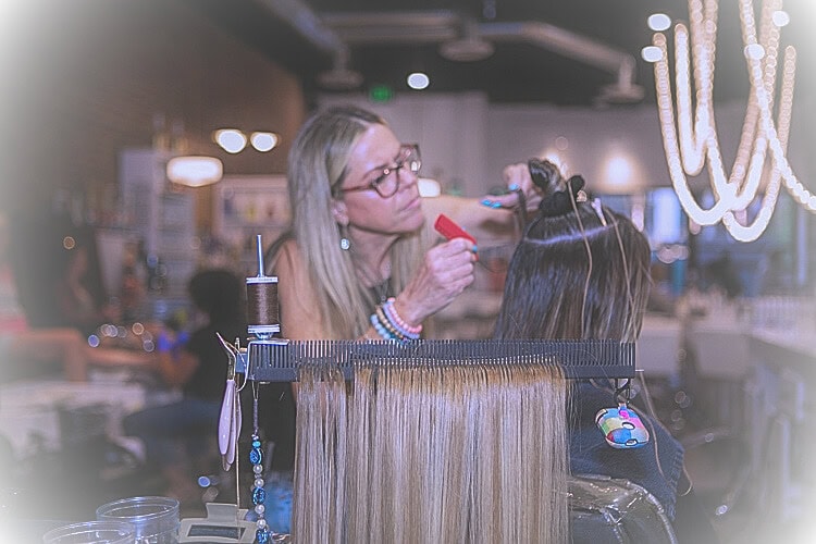 detailed stylist is ready to add extensions using Hair Butler™ hair extension workstation tool