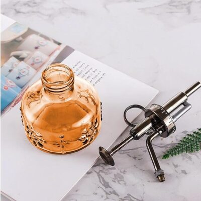 Glass spray bottle with nozzle on table Hair Butler™ hair extension workstation tool