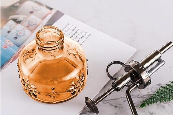 Glass spray bottle with nozzle on table Hair Butler™ hair extension workstation tool