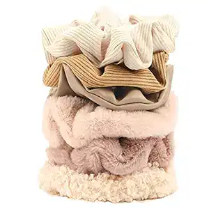Scrunchies in neutral colors in stack Hair Butler™ hair extension workstation tool