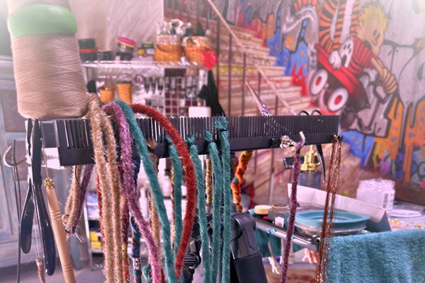 many different types of extension hair can be used with the Hair Butler™ hair extension workstation tool including colored dreadlocks